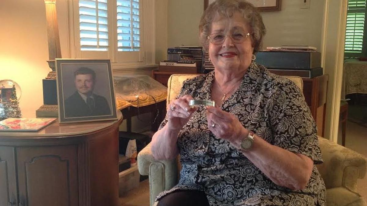 Margaret Williams, of Phenix City, holds a POW/MIA bracelet with the name Lt. Ben Purcell inscribed. The bracelet belonged to her son, Frank W. Williams III, who is shown in the photo. Frank died in 1974 from a rare bacterial infection.