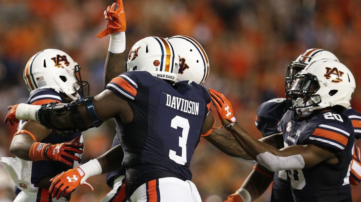Auburn linebacker Tre' Williams, center, puts his finger up after a quarterback sac in the second half of an NCAA college football game against Georgia Southern, Saturday, Sept. 2, 2017, in Auburn, Ala. Auburn won 41-7.
