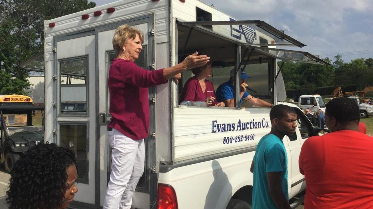 Ann Evans spots bidders during the surplus auction of mostly Columbus Water Works equipment on Saturday morning.