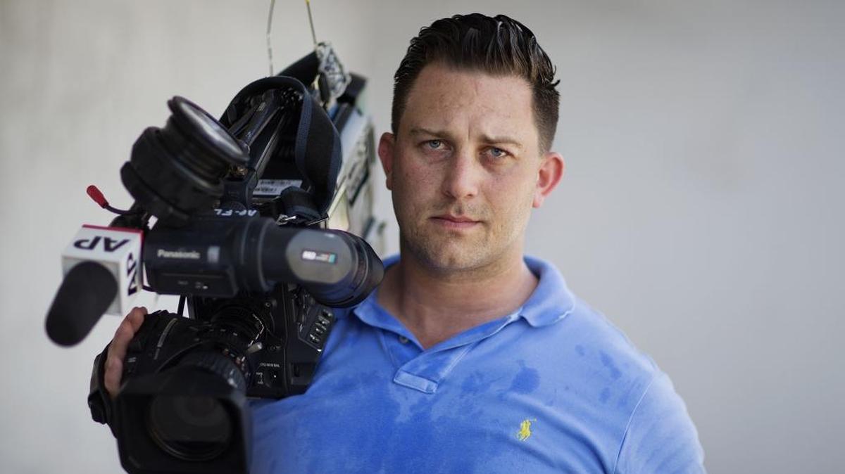 Associated Press video journalist Josh Replogle poses for a photo while taking a break from working the scene near a mass shooting at the Pulse nightclub Tuesday in Orlando, Fla. Replogle helped put himself through college by working at the Pulse dance club for two years. He returned this week to cover the mass shooting at the club.