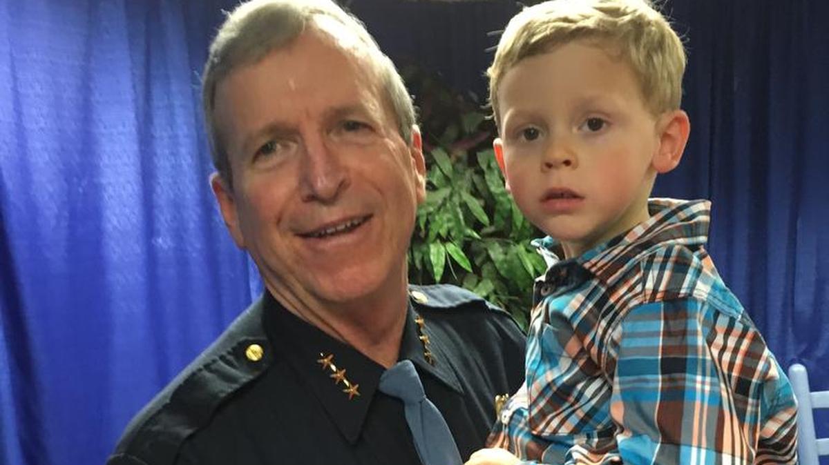 Lem Miller with his grandson, Ayden, Friday at Miller’s retirement ceremony as assistant chief of the Columbus Police Department.