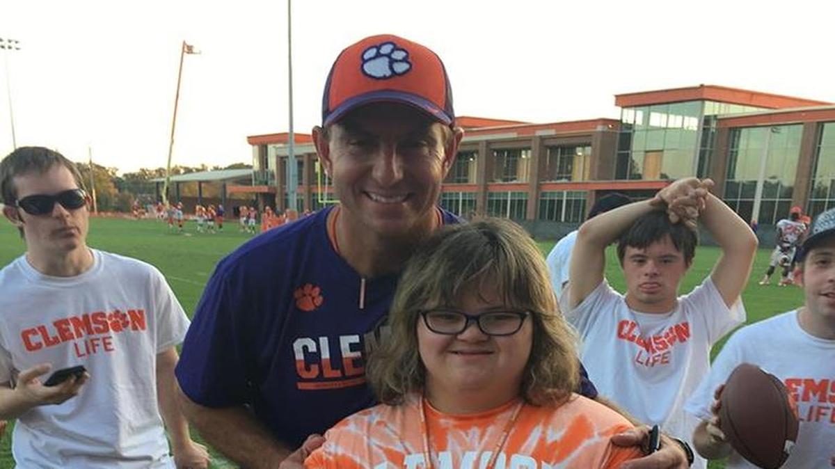Mason Hardin gets a hug and pose from Clemson football coach Dabo Swinney last week.