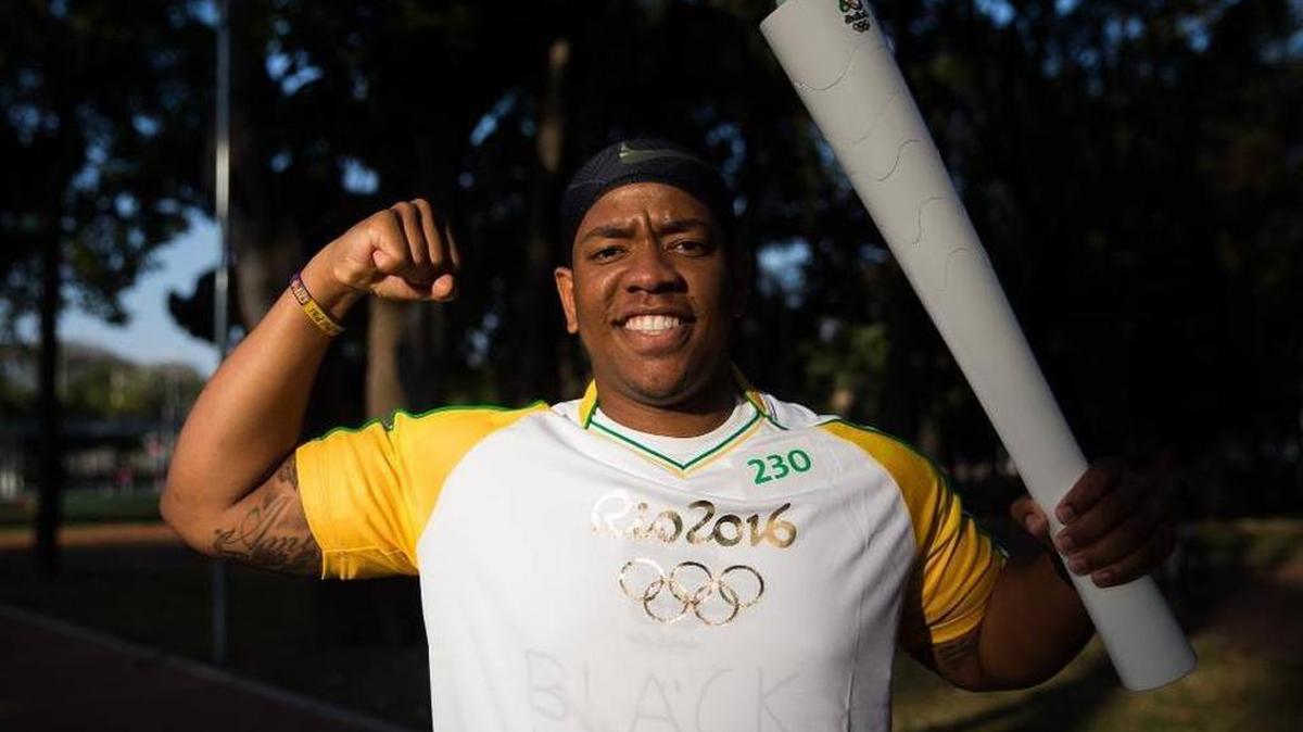 Leroy White poses with the Olympic Torce in Sao Paulo, Brazil.