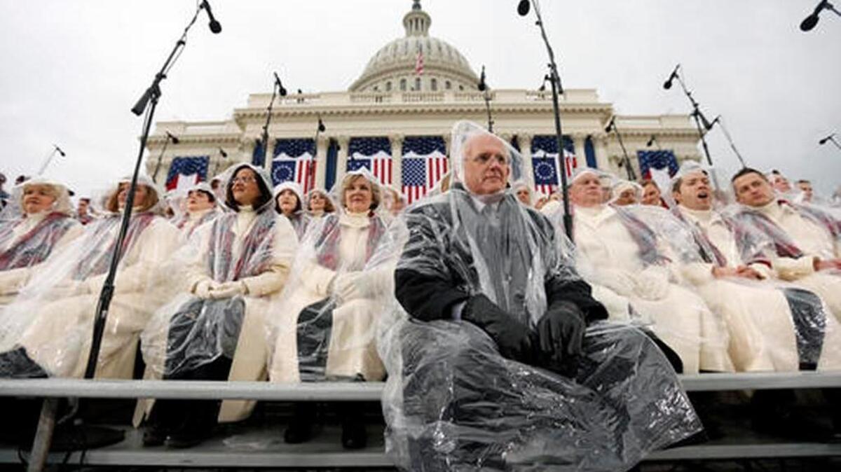 Members of the Mormon Tabernacle Choir sit in the rain waiting for the swearing in of Donald Trump as the 45th president of the United States to begin during the 58th Presidential Inauguration at the U.S. Capitol in Washington.