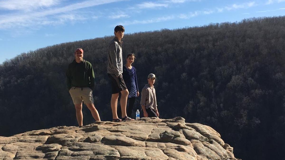 The Kendrick-Holmes children stand on Hawksbill Crag in Kingston, Ark., one of the stops on their nearly 2,000-mile holiday road trip.