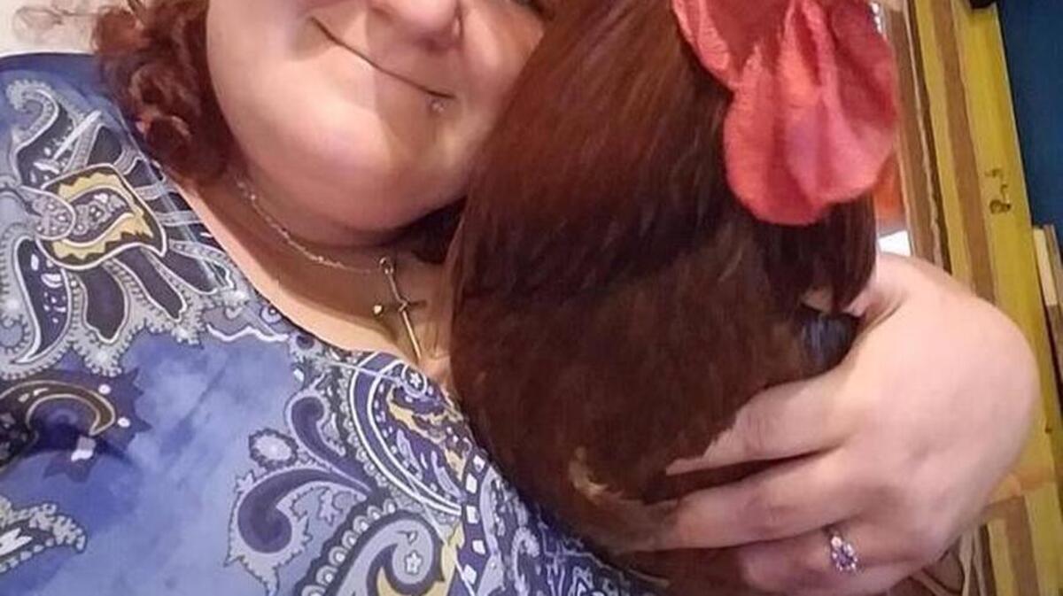 Sally Mroz and her rooster, Big Red, in happier times.