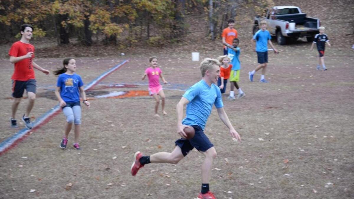 A high-scoring backyard football game is the best kind. Here, Stephen Hellier runs to daylight.