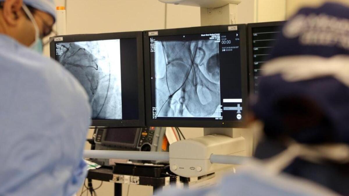In this 2015 file photo, doctors in the catheterization lab at Mount Sinai Medical Center do a simulation of opening up a blocked artery in the heart.