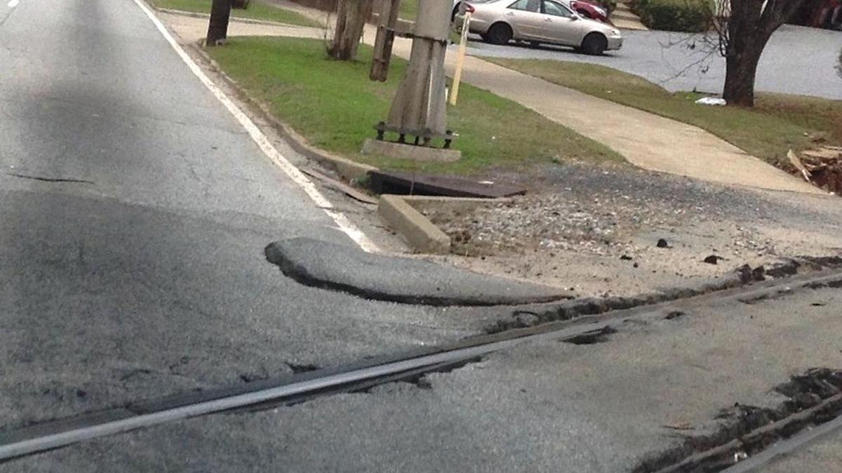 Excess asphalt causes extra jarring ride or causes drivers to swerve on Second Avenue.