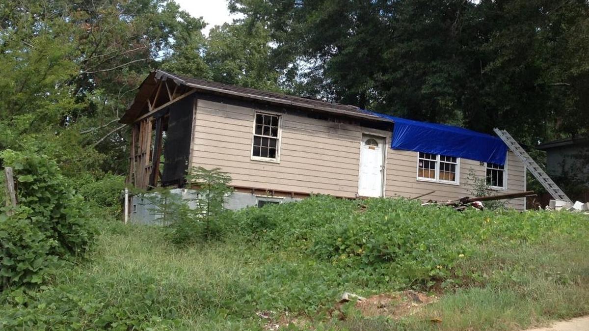 One of three Patton Drive houses that have tarps on their roofs.