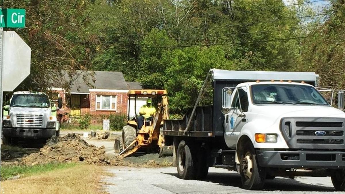 A Columbus Water Works crew works on repairing a water leak that has plagued the Baker Court and Baker Circle area.