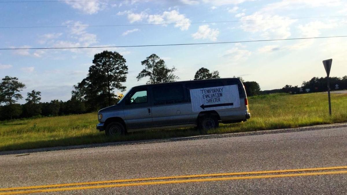 A banner affixed to a church van directs storm evacuees on U.S. 431 to a shelter at the Silver Run Baptist Church in Seale, Ala.