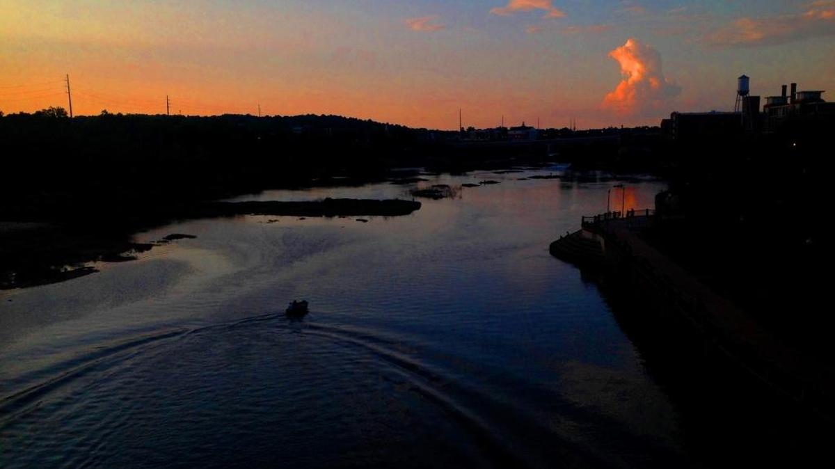 A boat goes up the Chattahoochee River north of Dillingham Street at sunset Saturday, May 14, 2017