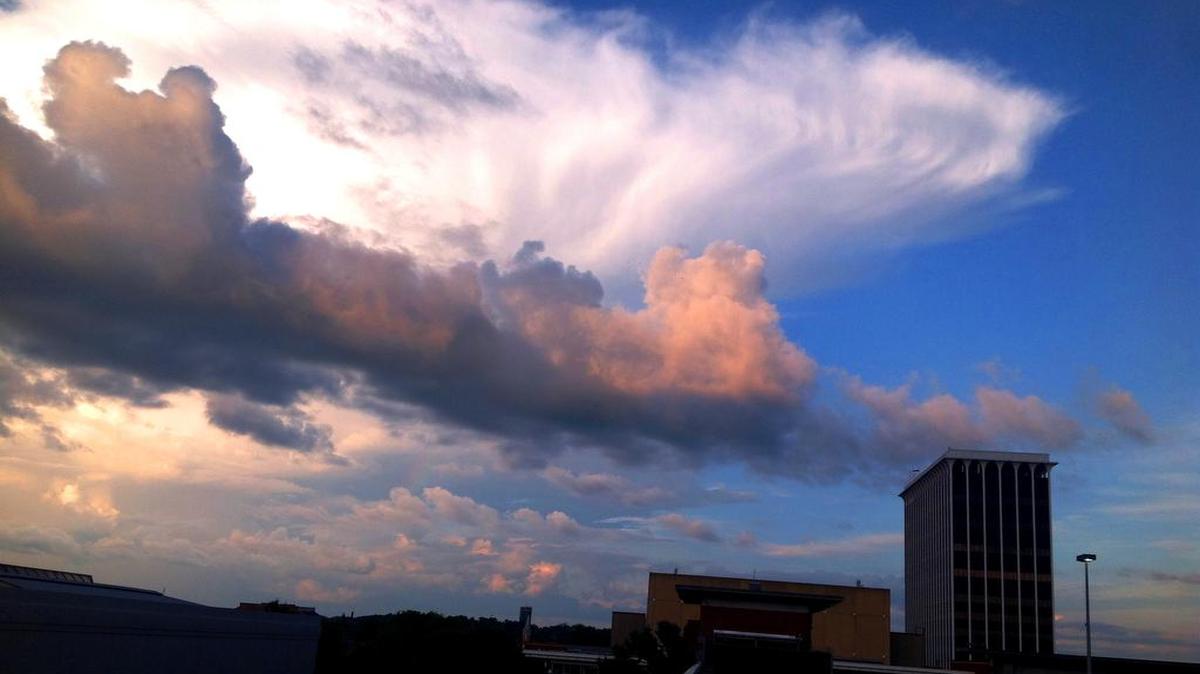 A summer sunset lights a cloud over the Columbus Government Center tower.