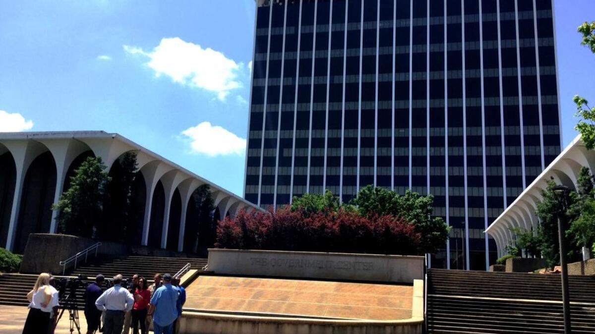 City leaders hold a news conference outside the Government Center after a pipe burst on the top floor, flooding courtrooms and offices below.