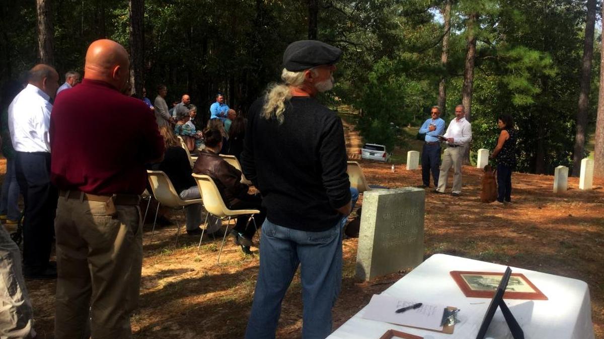 Dent Williams son George “Trey” Williams speaks at a Saturday memorial service.