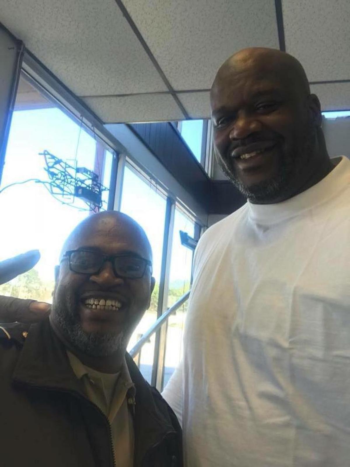 Sgt. Everette Brockington, at left, is all smiles after meeting former Lakers great Shaquille O’Neal at Shirley’s Country Kitchen in LaGrange on Friday.