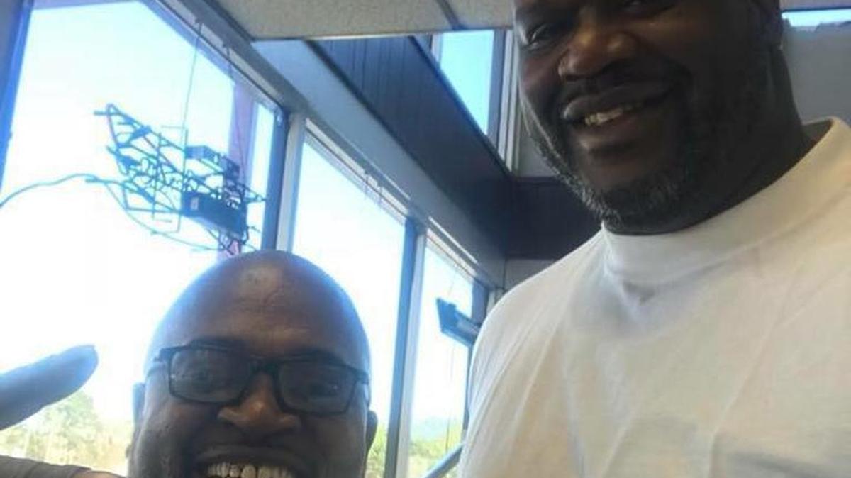 Sgt. Everette Brockington, at left, is all smiles after meeting former Lakers great Shaquille O’Neal at Shirley’s Country Kitchen in LaGrange on Friday.