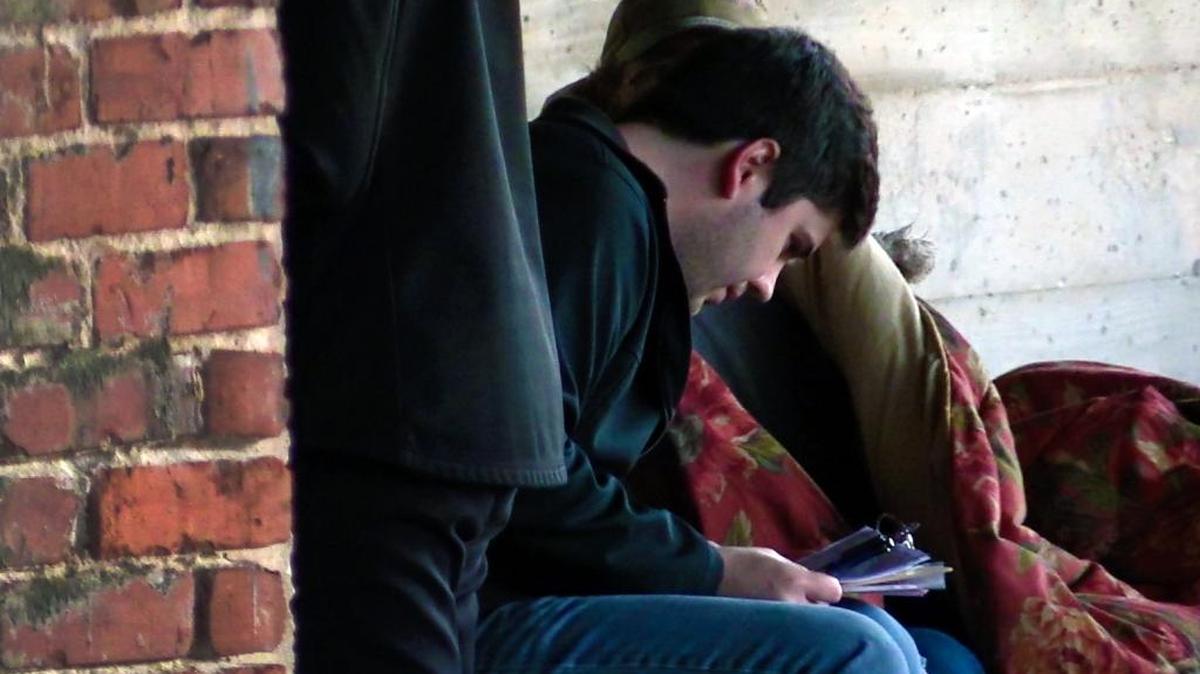 FILE -- Mitch Kilday surveys a member of the homeless community in Phenix City during the 2017 "Point-In- Time" count. The program is an effort to count and survey homeless individuals in the community.