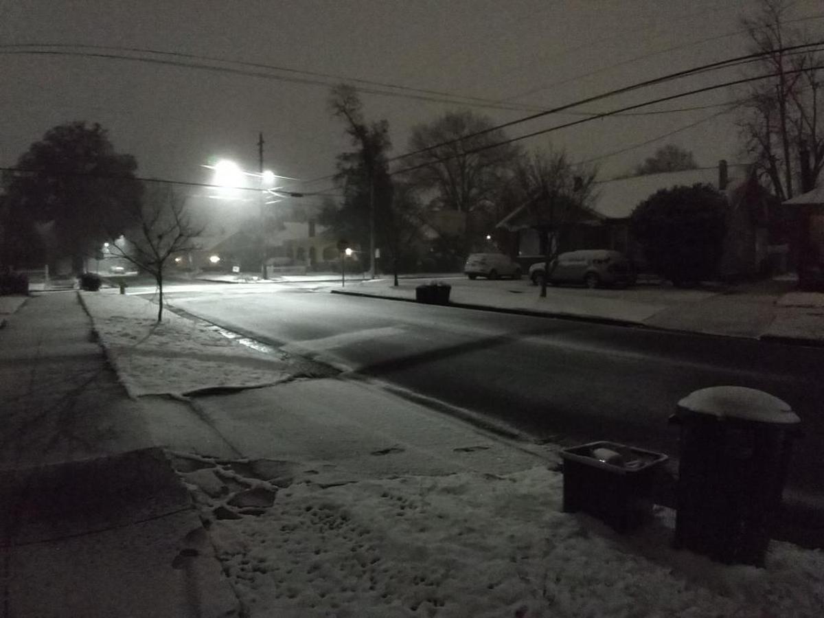 Snowfall left streets slick and cars iced over