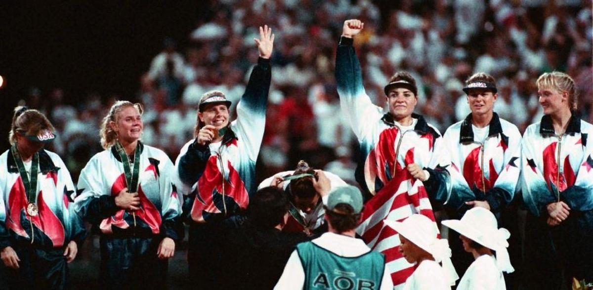 USA Softball left fielder Kim Maher receives her gold medal as Dot Richardson, left, and Lisa Fernandez raise their arms in celebration at Golden Park in Columbus in this August 1996 Ledger-Enquirer file photo. Teammates from left, Julie Smith, Dionna Harris, Richardson, Maher, Fernandez, Shelley Stokes and Laura Berg. The U.S. beat China 3-1 for the first softball gold medal in Olympic history.