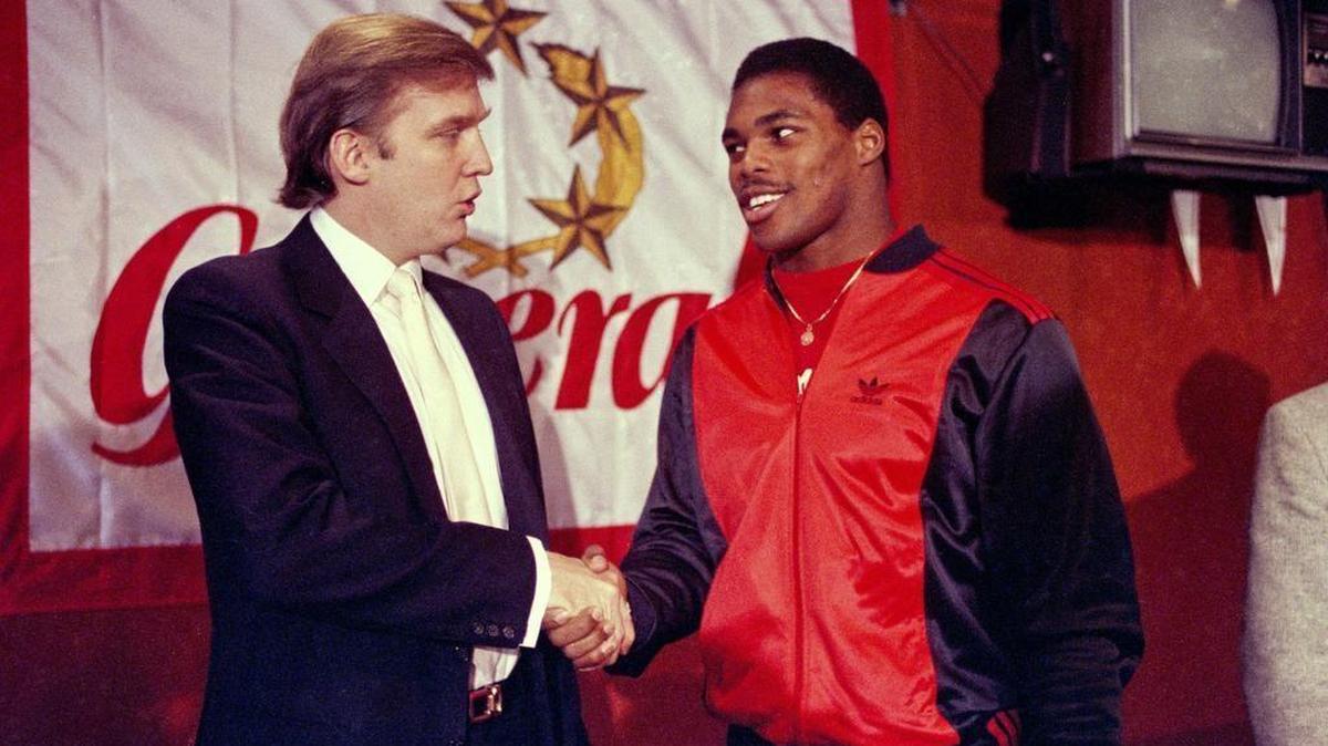 FILE - In this March 8, 1984, file photo, then-New Jersey Generals owner Donald Trump, left, shakes hands with Herschel Walker at a press conference in New York, after agreeing on a four-year contract. (AP Photo/Dave Pickoff, File)