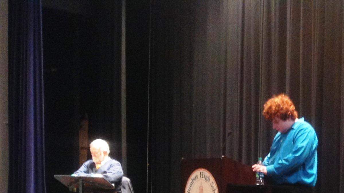 Mayor Teresa Tomlinson answers a question from moderator David Smith as former state Sen. Seth Harp, seated because of knee surgery, listens Wednesday night at Columbus High School.