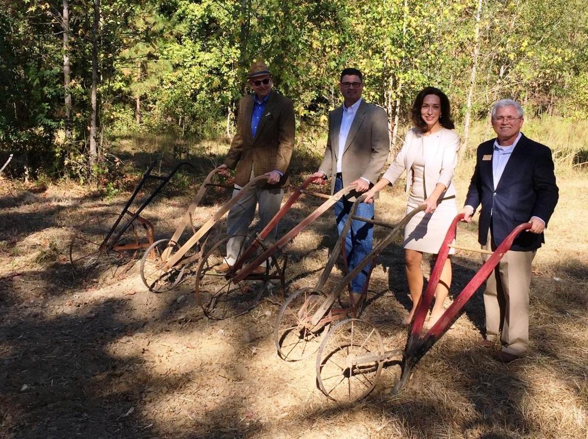 Historic Westville Executive Director Leo Goodsell (right), Mayor Teresa Tomlinson, Westville Executive Committee Chair Tripp Blankenship and Convention and Visitors Bureau President Peter Bowden push plows to break ground for the museum in 2016.