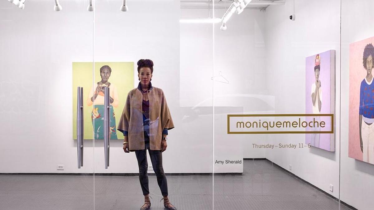 Amy Sherald, a Columbus native, stands in front of her painting “What’s different about Alice is that she has the most incisive way of telling the truth” at the Monique Meloche Gallery in Chicago. The painting was recently purchased by the Columbus Museum.