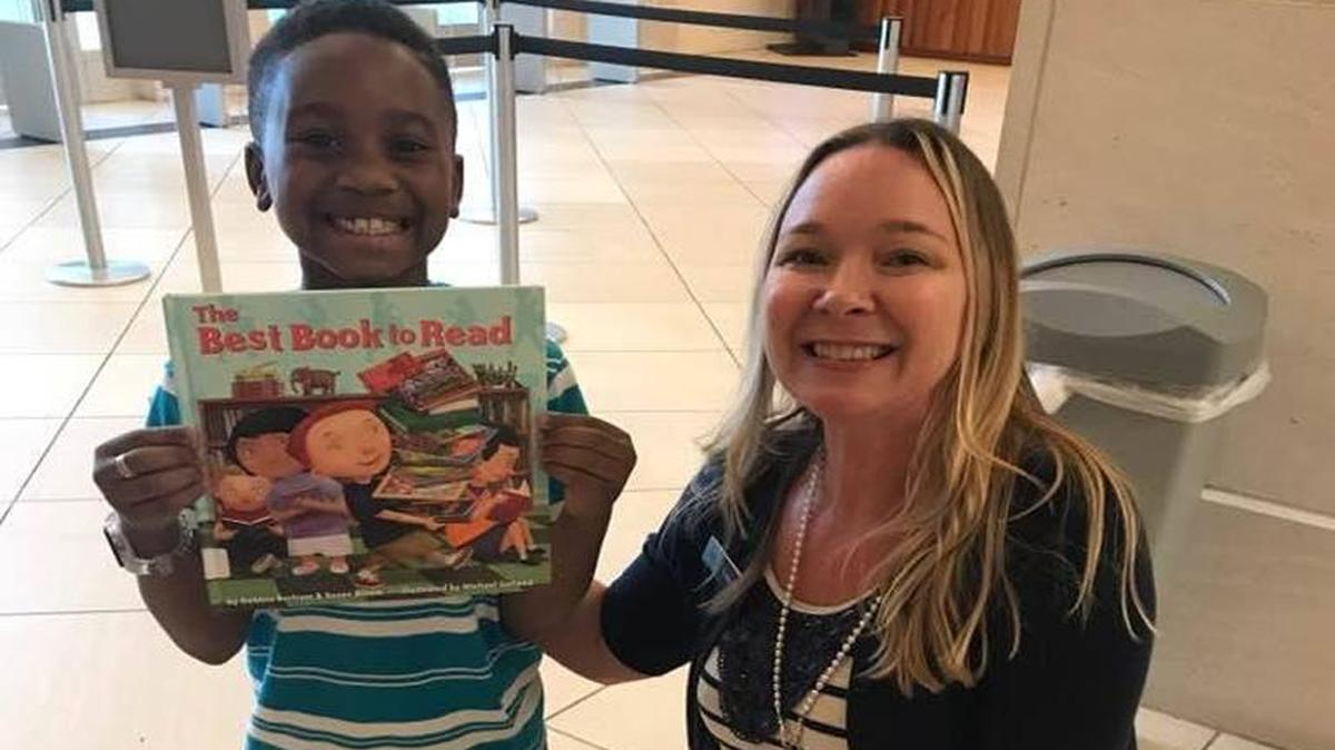 Zavien poses with Leisa Blankenship, from the circulation department