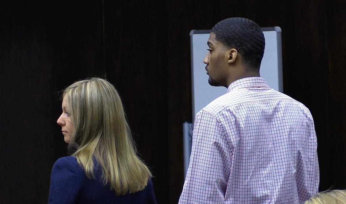 Rufus Leonard Burks IV, right, and his defense attorney Jennifer Curry stand as jurors enter the courtroom Monday morning.