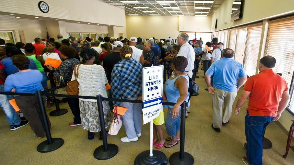 People stand in line to vote early at the new Board of Elections building in Macon, Ga.