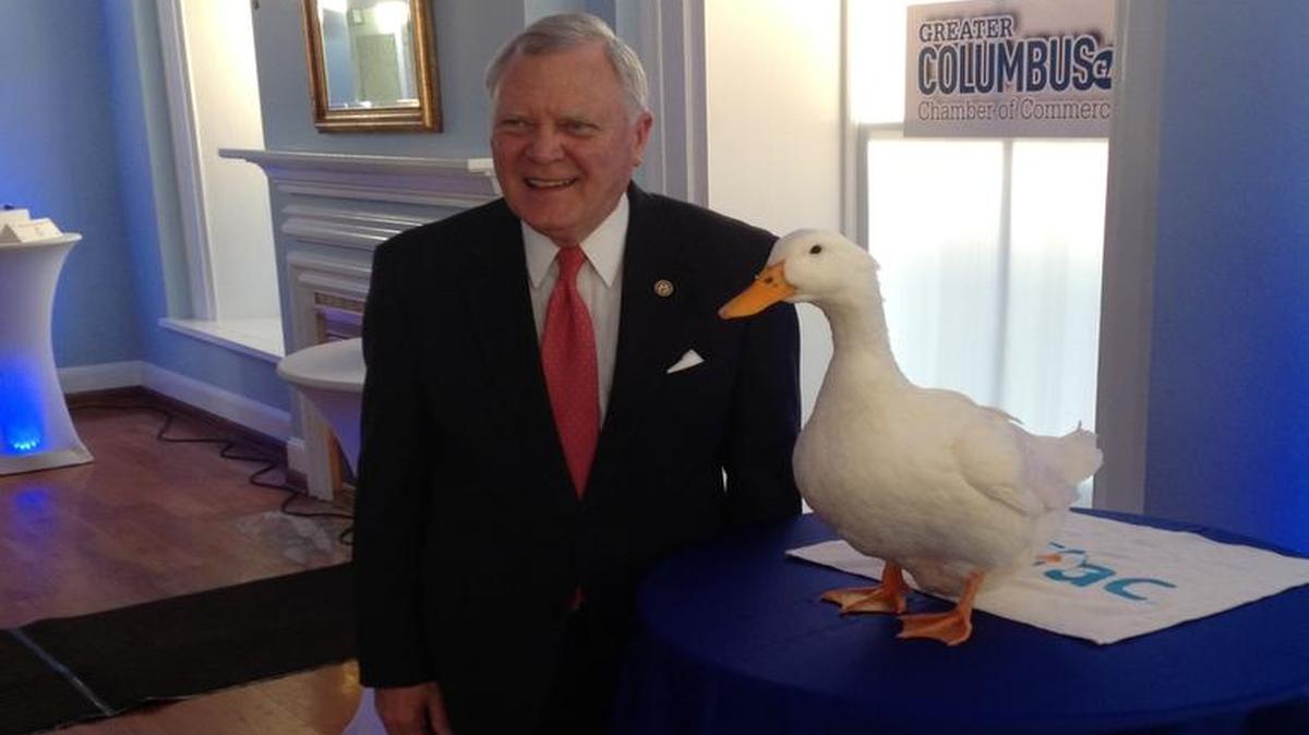 Gov. Nathan Deal poses with the Aflac Duck during a visit from a group of political and business leaders from Columbus.