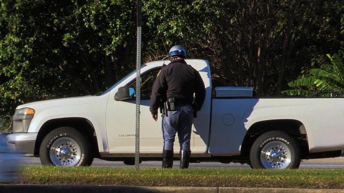 FILE -- A Columbus Police officer speaks with a driver after stopping them on Victory Drive in Columbus.