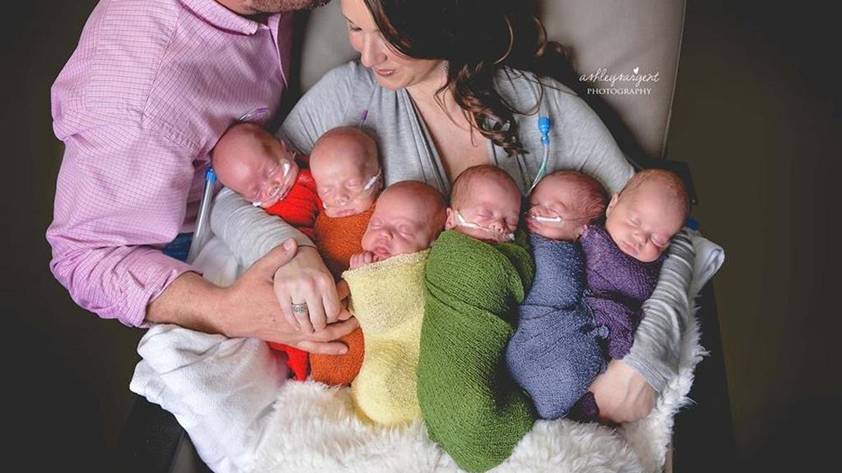 The parents with their six newborn sextuplets at the hospital.