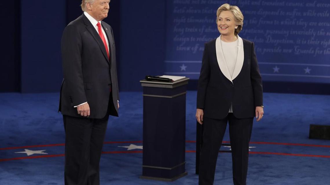 Republican presidential nominee Donald Trump and Democratic presidential nominee Hillary Clinton arrive for the second presidential debate at Washington University in St. Louis, Sunday.