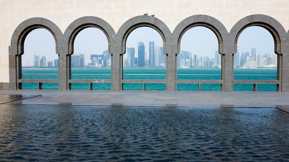 Doha’s skyline is seen through the Moorish arches of the Museum of Islamic Art.