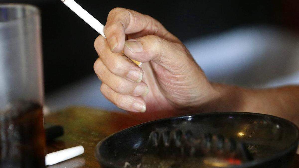 FILE - In this April 21, 2015, file photo, a patron smokes a cigarette inside a bar in New Orleans.