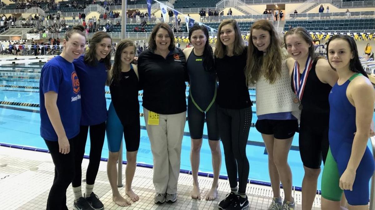 Columbus’ Kaleigh Feger, Katie Jordan, Lindsey Conroy, head coach Karen Waters, Allie Murphy, Tori Abeyta, Nyssa Goodroe, Ashlyn Steinbach and Madigan Starr pose during the 2016-2017 Swimming & Diving State Championships in Atlanta.