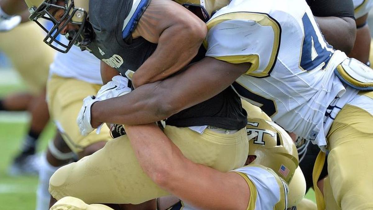 Georgia Tech defensive lineman Adam Gotsis (on ground) makes a tackle against Wofford during the 2014 season.