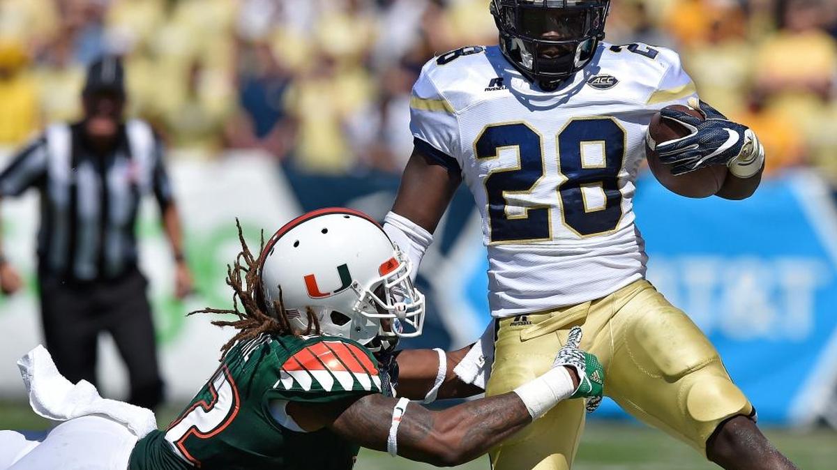 Miami defensive back Sheldrick Redwine (22) tackles Georgia Tech running back J.J. Green (28) during the first half last Saturday.