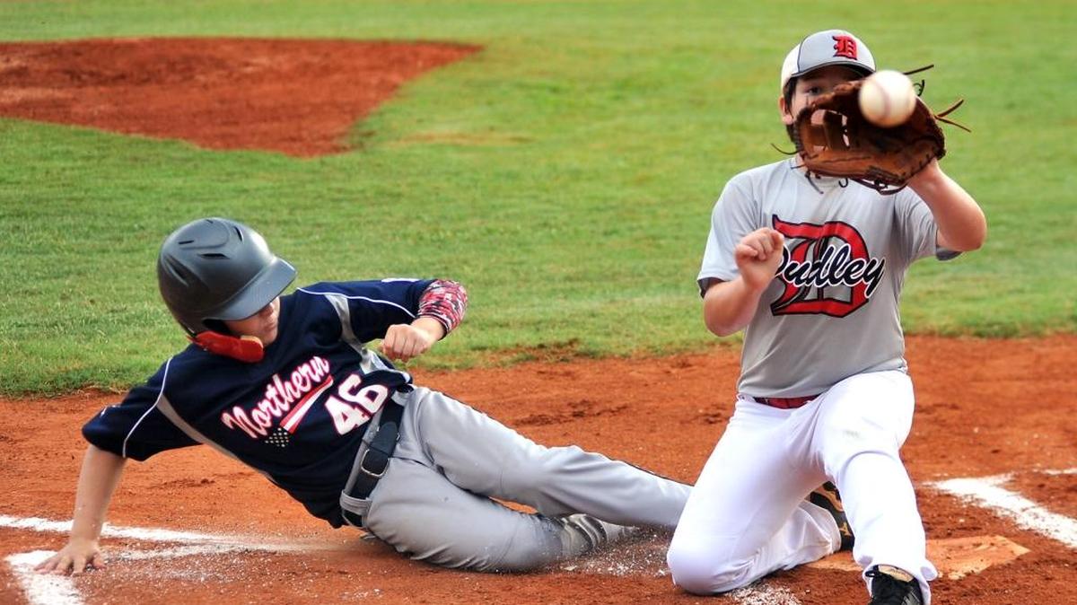 Northern's Colton Masse slides into home plate beating the tag of Dudley’s Matthew Thigpen in the 1st inning of the 10-11 State Tournament at Sally Little League in Columbus July 12, 2016