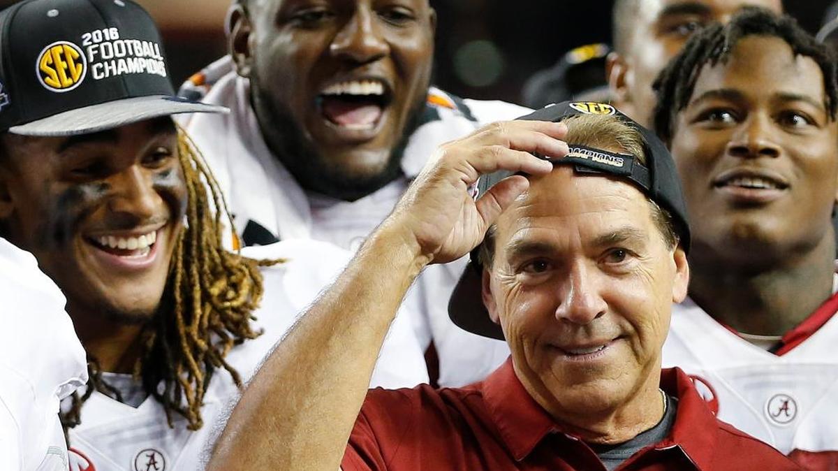 Alabama head coach Nick Saban and team members celebrate after the Southeastern Conference championship NCAA college football game against Florida, Saturday, Dec. 3, 2016, in Atlanta. Alabama won 54-16.