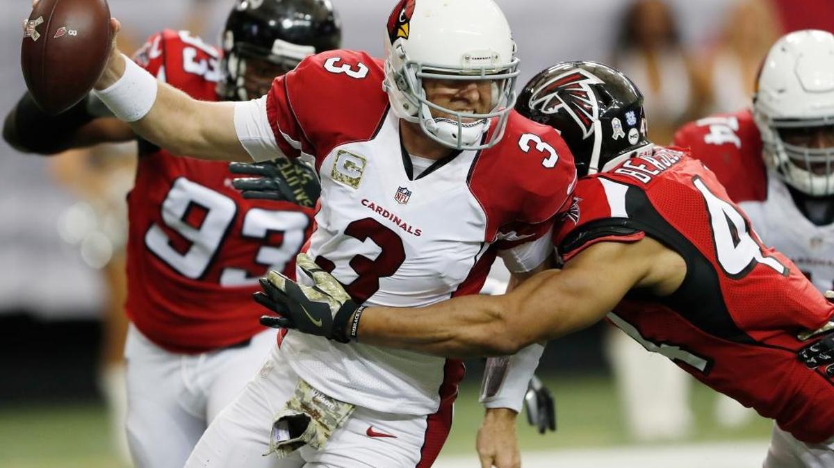 FILE - In this Nov. 27, 2016, file photo, Atlanta Falcons outside linebacker Vic Beasley (44) hits Arizona Cardinals quarterback Carson Palmer (3) behind the line of scrimmage during an NFL football game in Atlanta. "Looking back to last year, I think we got through most of the year with the same guys," said Palmer, whose current line includes two players who weren't starters when the season began and a third lineman playing out of his usual position. "This year, it's been the exact opposite. It's been different guys, different spots, different weeks." The Cardinals, who made the NFC title game last year, are 4-6-1 this season.