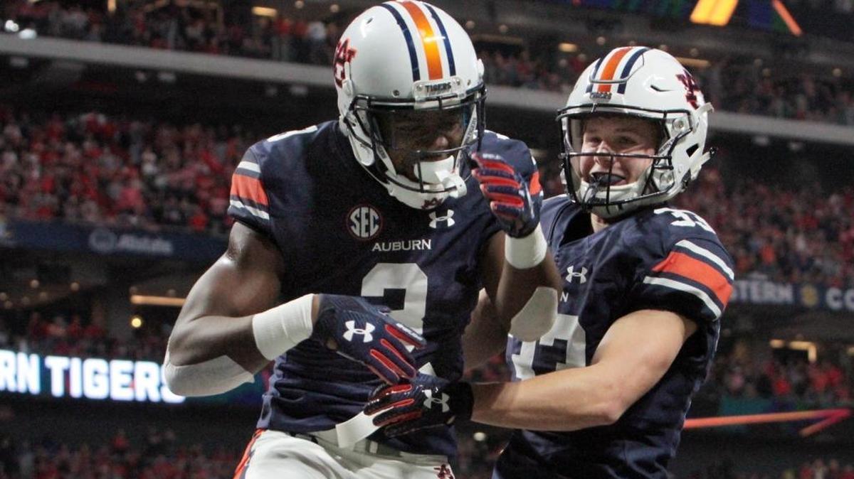 Auburn's Nate Craig-Myers (3) celebrates with wide receiver Will Hastings after his first quarter score against Georgia in the 2017 SEC Championship at Mercedes Benz Stadium in Atlanta Saturday.