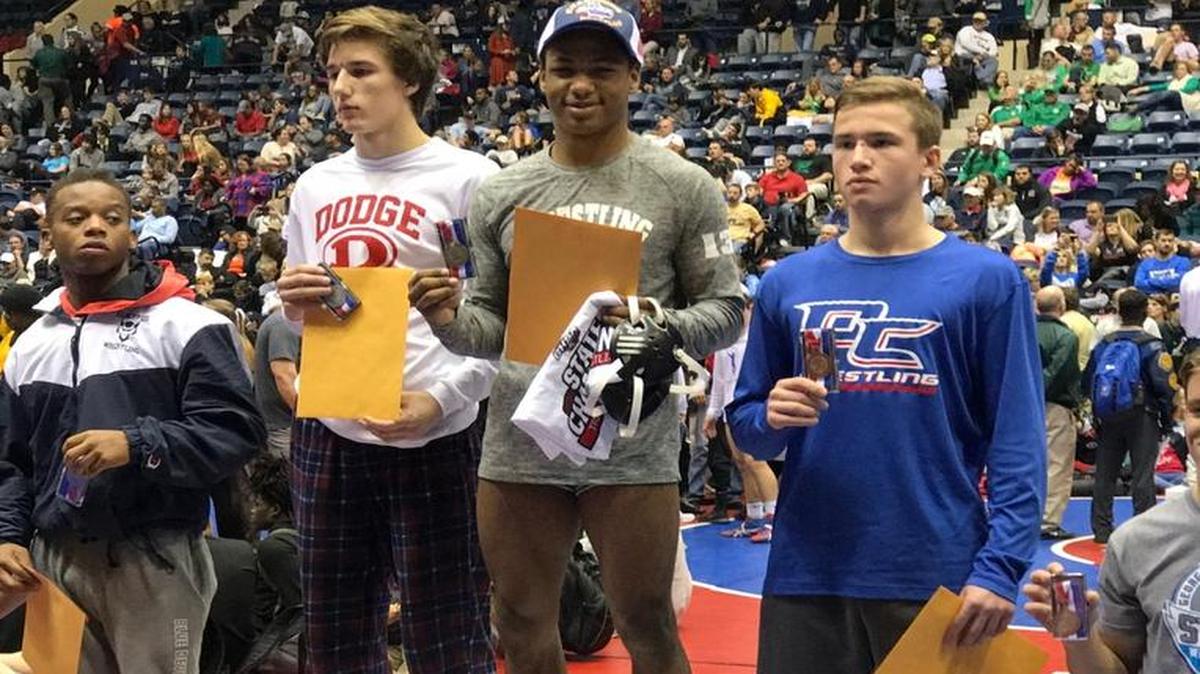Spencer High School wrestler Elijah McNickles (third from left) celebrates his state title in Macon on Saturday, February 11, 2017.