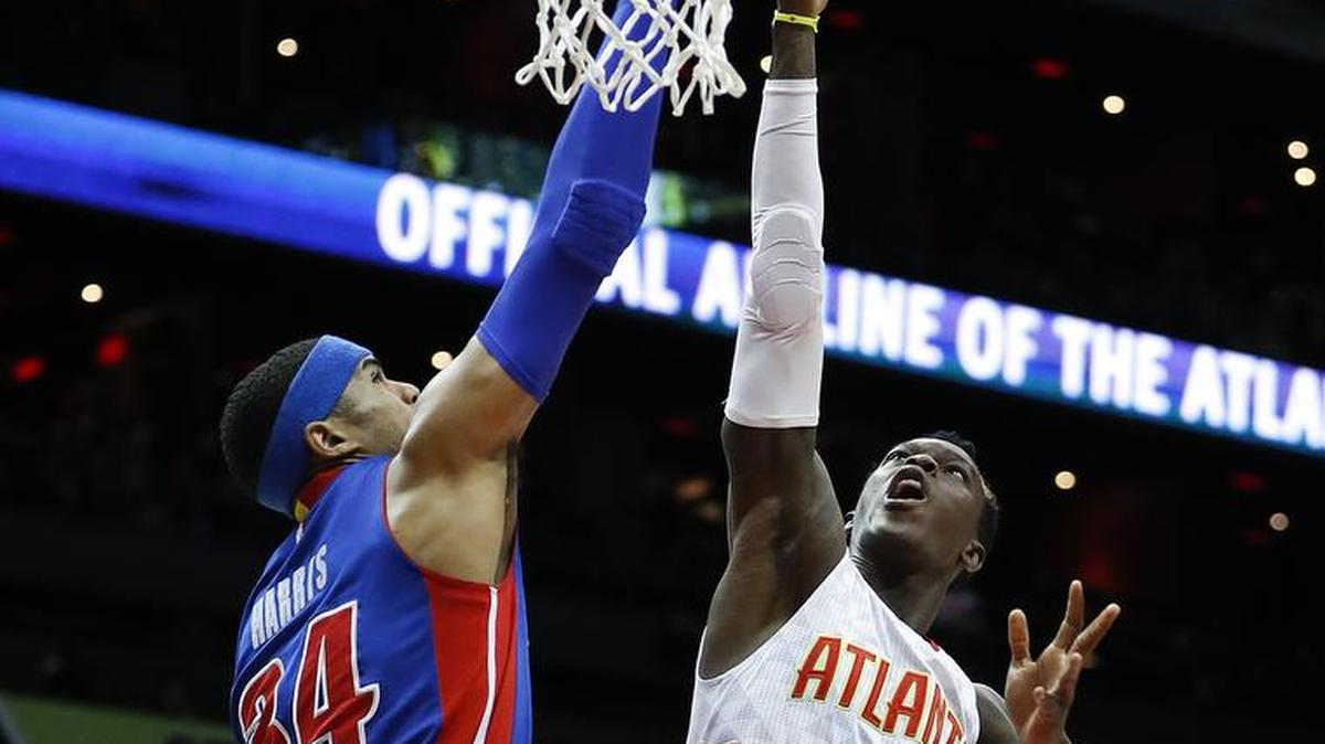 Atlanta Hawks guard Dennis Schroder (17) goes up to shoot as Detroit Pistons forward Tobias Harris (34) defends in the first half of Friday’s game in Atlanta.