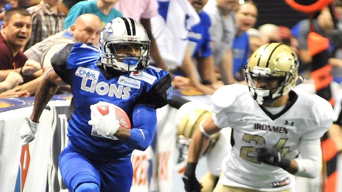 Columbus Lions' John Harris makes the pass reception and races past Michigan's Deonte'  for the touchdown during the AIF championship game on June 18.