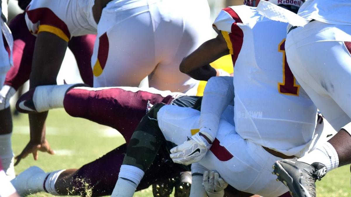 On the first play of the game, Morehouse’s David Smith sacks Tuskegee’s Kevin Lacey during the Tuskegee-Morehouse Classic Football Game Saturday afternoon.