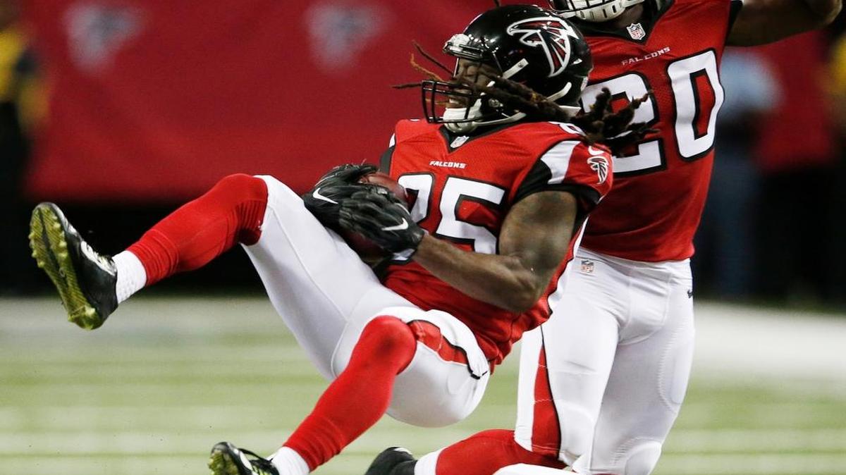 Atlanta’s J.D. McKissic is brought down by Redskins defensive back Jeremy Harris during the second half Thursday night.